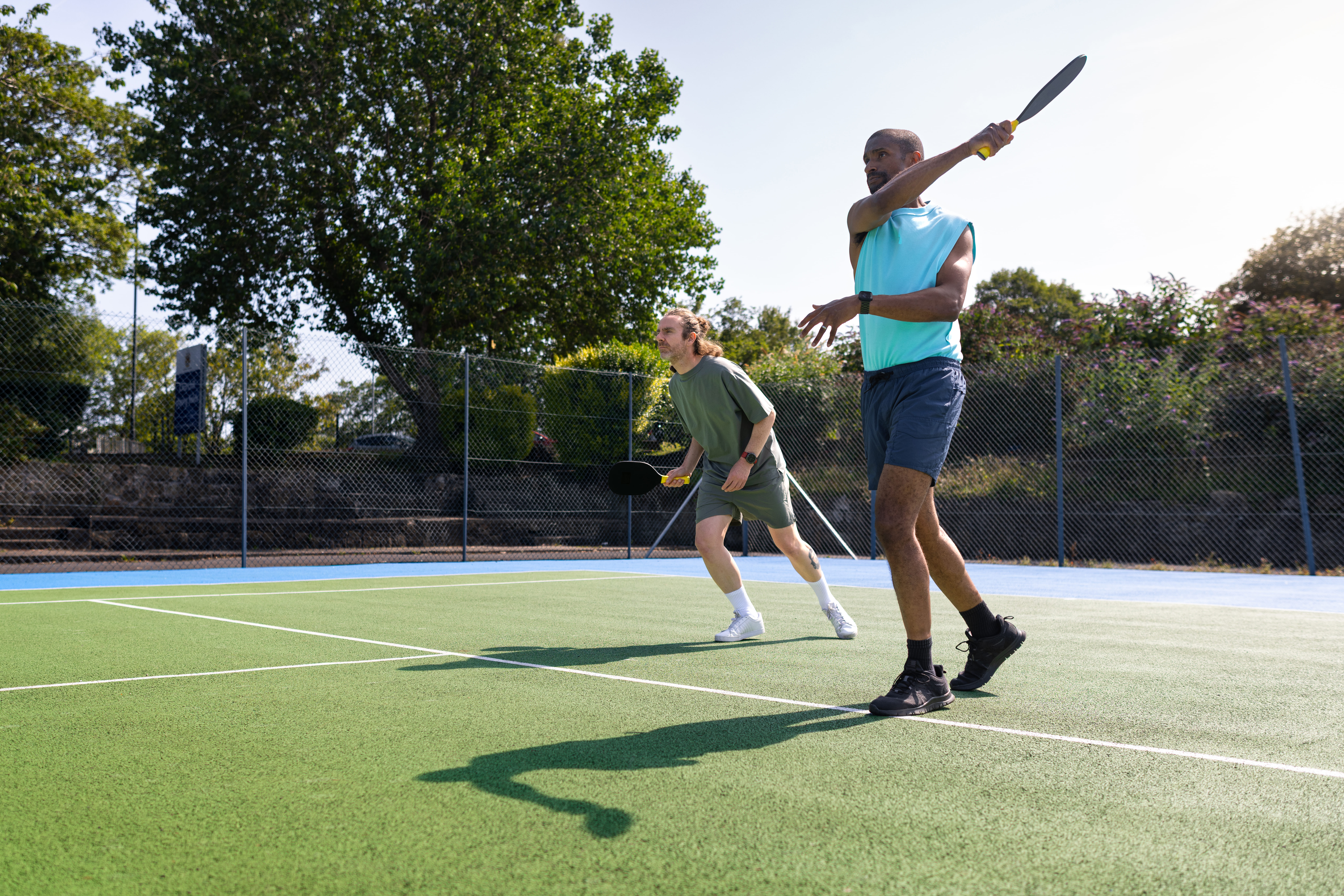 Two people playing padel